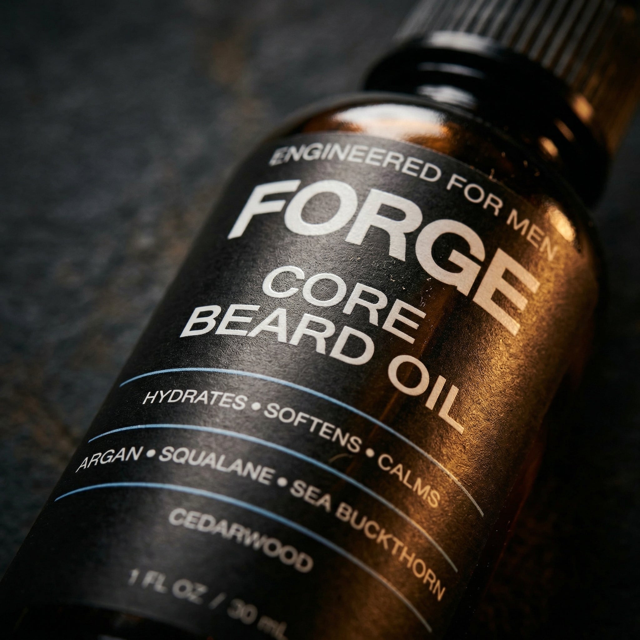 Close-up of the FORGE Core Beard Oil label on dark slate